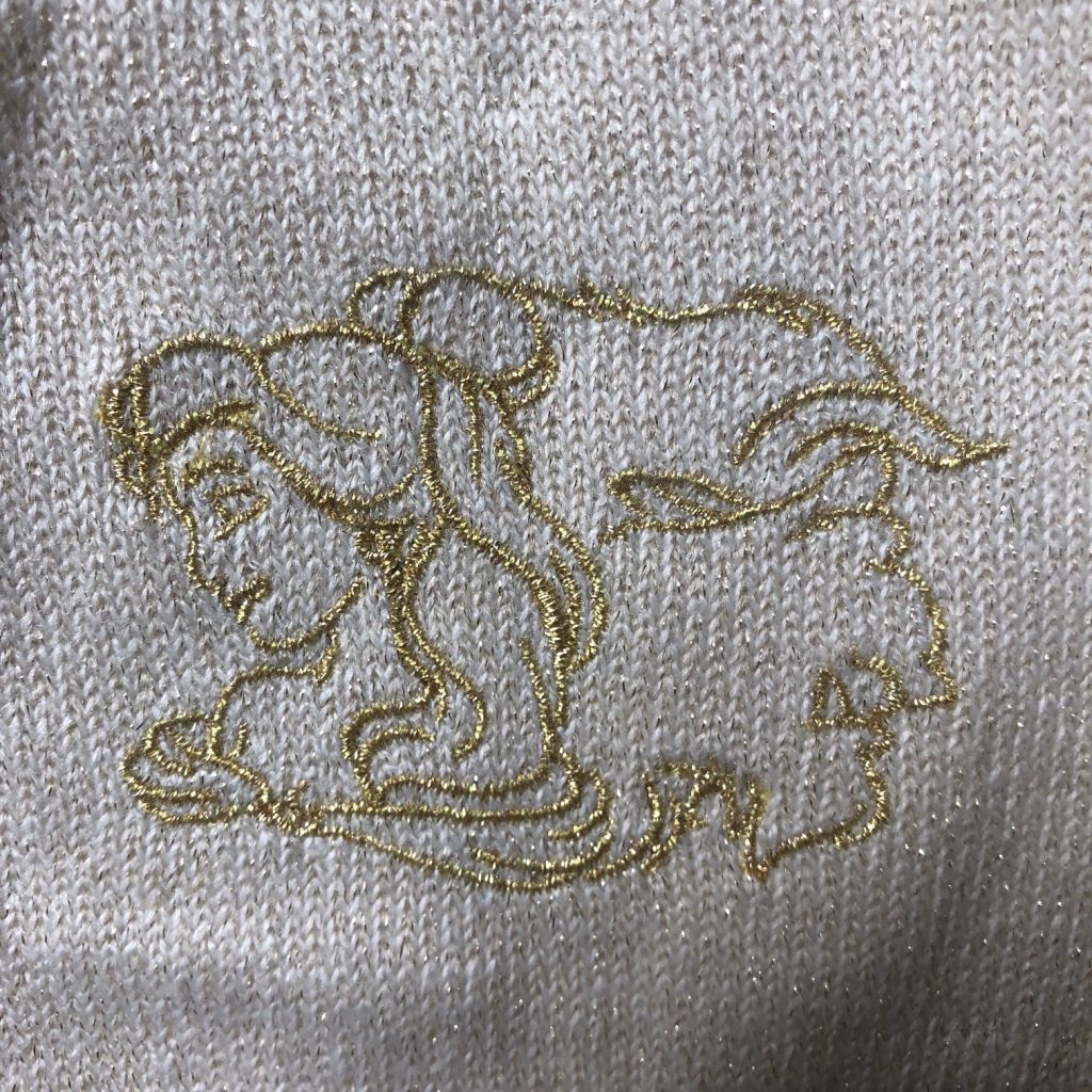 Embroidery of Belle and the Beast in gold