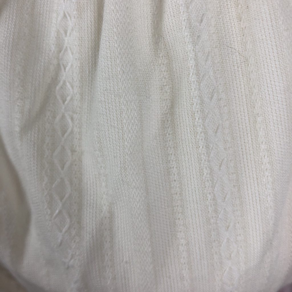 Pattern on the white fabric of the dress
