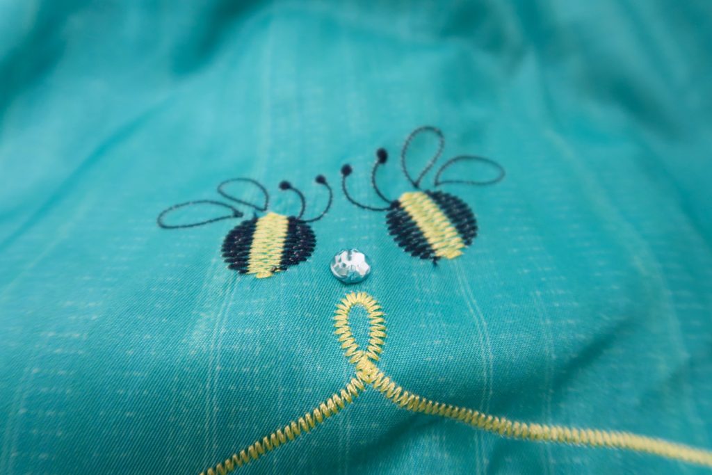 Emboidery detail: Bumblebees with rhinestone and ribbon on skirt