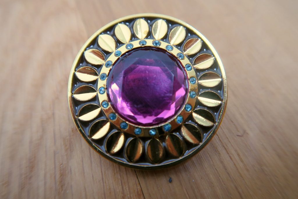 Close Up Golden Brooch with Ruby and Emerald